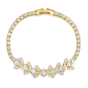 Detail of gold tennis bracelet featuring princess and baguette cut sparkling cubic zirconia