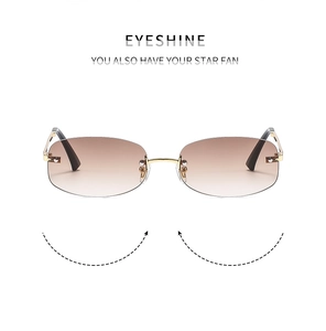 Detail view of EYESHINE rimless sunglasses with brown gradient lenses and gold metal arms
