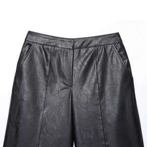 High-waisted black faux leather shorts featuring front pleats and side pockets for women