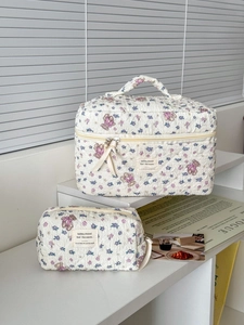 Detailed close-up of quilted floral bear makeup bag set with texture and zip detail