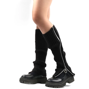 Detail of black knitted leg warmers with side zipper styled with chunky platform shoes