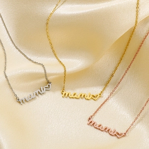 Three mama heart necklaces in silver, gold, and rose gold on champagne silk