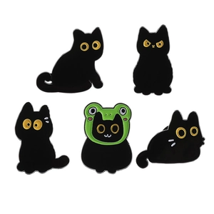 Set of five cute black cat enamel brooches with creative frog hat design on white background