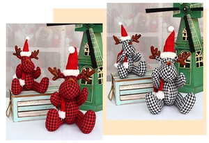 Detail of Christmas reindeer plush toys featuring red black plaid and festive scarves