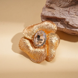 Detailed macro of golden floral brooch with champagne crystal and sparkling rhinestones