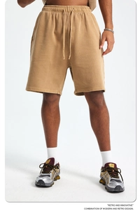 Detail of drawstring waistband and vintage washed cotton fabric on men's sport shorts