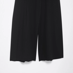 Women's black high-waist wide-leg trousers featuring a loose fit and casual pleats