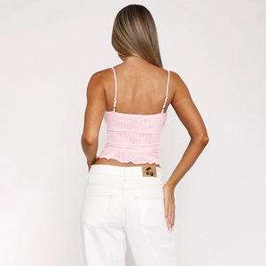 Rear view of pink lace camisole with adjustable straps and ruffled hem detail