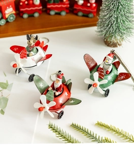 Close-up of vintage metal Christmas planes with Santa, Snowman and Reindeer ornaments