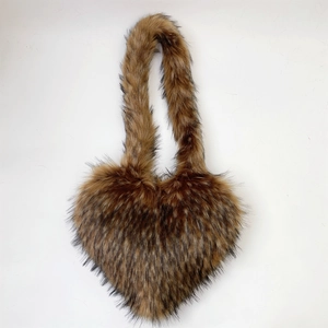 Detail of heart-shaped faux fur crossbody bag with fluffy brown-black faux raccoon hair texture