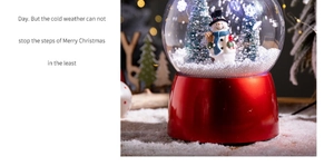 Detail of Christmas snowman snow globe with red base and warm glowing lights