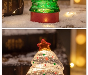 Close-up of a glowing Christmas tree tabletop lamp with swirling glitter and liquid