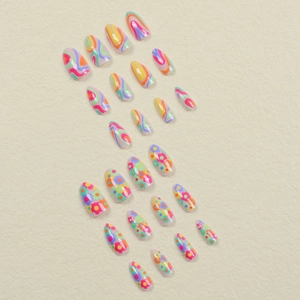 Medium almond press-on nails with rainbow swirl patterns and colorful flower designs
