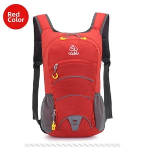 Detailed front view of a red lightweight outdoor backpack with multi-layered zipper pockets