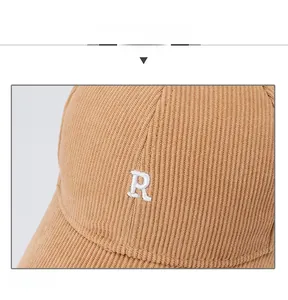 Macro shot of khaki corduroy texture and white 3D embroidered letter R on baseball cap