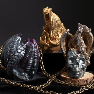 Gothic dragon on skull silicone mold statues in gold, silver, and purple glitter finishes