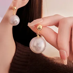 Elegant gold plated drop earrings featuring large round white pearls and minimalist studs