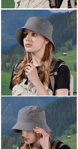 Detail of gray outdoor sun hat with side ventilation holes and adjustable chin strap