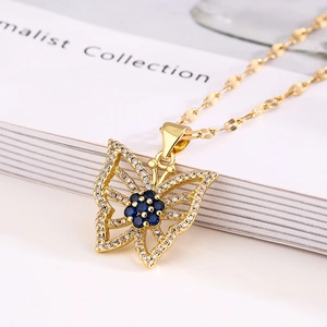 Gold butterfly necklace featuring blue gemstones and clear zircon on fine link chain