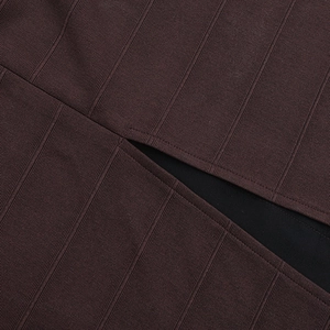 Detail shot of deep brown ribbed knit fabric with precise stitching and inner lining texture