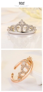Close-up of crown ring with cubic zirconia inlay showing adjustable open band detail
