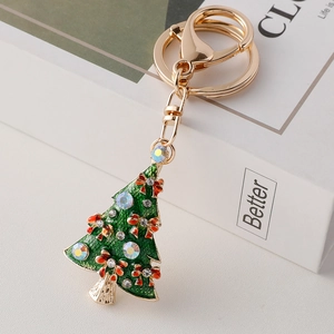 Christmas tree keychain with green enamel, red bow, and rhinestones on gold alloy base