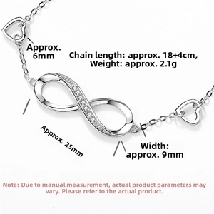 Detailed view of silver infinity bracelet with pavé stones and hollow heart charm details