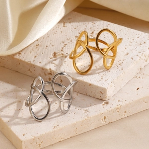 Minimalist geometric stainless steel rings in gold and silver finish on stone