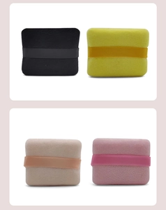 Detailed view of soft velvet makeup puffs in four colors with ribbon handles