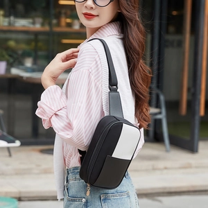 Women's casual black and white crossbody chest bag with adjustable strap on model