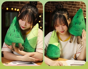 Detail of creative pine tree and bamboo shoot plush toys held by a model in a warm setting