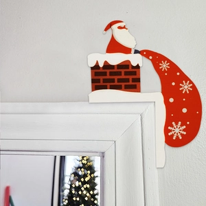 Detail of wooden Santa Claus corner decor popping out of chimney with a red gift bag