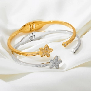 Star-shaped open bangle set in gold and silver finish with zircon stones on silk
