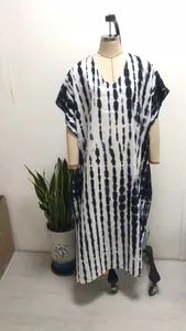 Detail showing the white and blue vertical tie-dye knit beach kaftan with pink cuff piping