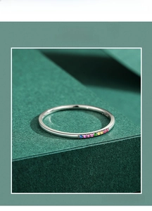 Macro detail of slim S925 silver ring featuring gradient rainbow micro-set turquoise stones
