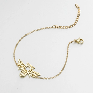 Detailed close-up of a hollow origami bee pendant on a dainty gold stainless steel chain