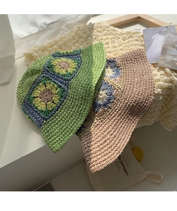 Close-up of hand-woven crochet sun hats with floral patterns and bubble texture