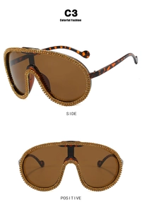 Close-up of rhinestone detailing on brown oversized shield frame cycling sunglasses