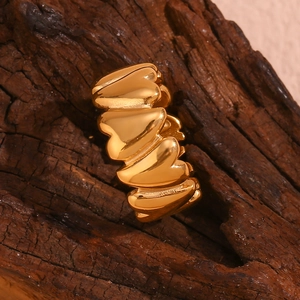 Detailed view of 18K gold plated stainless steel ring with linked heart patterns