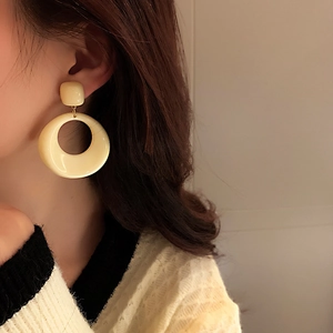 Vintage retro geometric cream acrylic hoop earrings for women shown on model