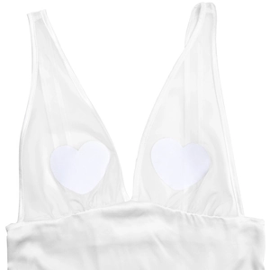 Detail of white sheer camisole with heart-shaped patches and silky hem texture
