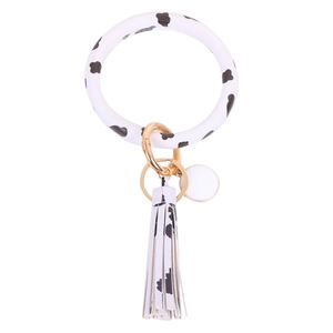 Siliconen armband sleutelhanger met koeienprint en witte lederen kwast met goudkleur