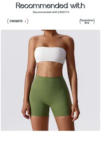 Detail view of high-waisted grass green yoga shorts and white sports bra workout set