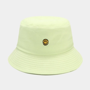 Close-up of classic yellow smiley face embroidery on a premium cotton bucket hat