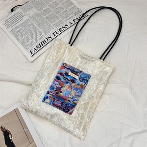 Detail of canvas tote with colorful abstract oil painting pocket and minimalist black handles