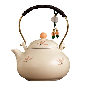 Ceramic teapot with floral pattern, beige glaze, and rope-wrapped metal handle