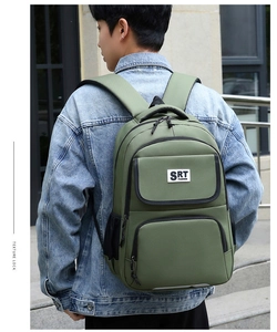 Outdoor back view of a durable green business casual backpack for daily commute