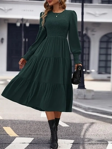 Elegant dark green long-sleeve midi dress with ruffled cuffs and a layered cake skirt