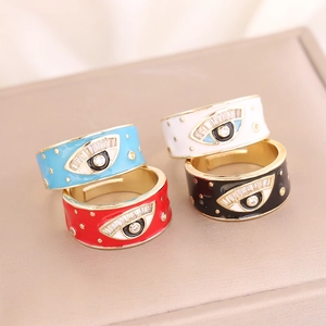 Detail of four colorful evil eye rings with enamel finish and sparkling cubic zirconia stones