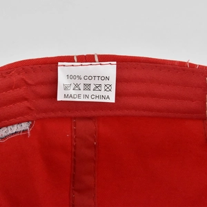 Macro shot of 100% cotton material label and care symbols on washed baseball cap interior